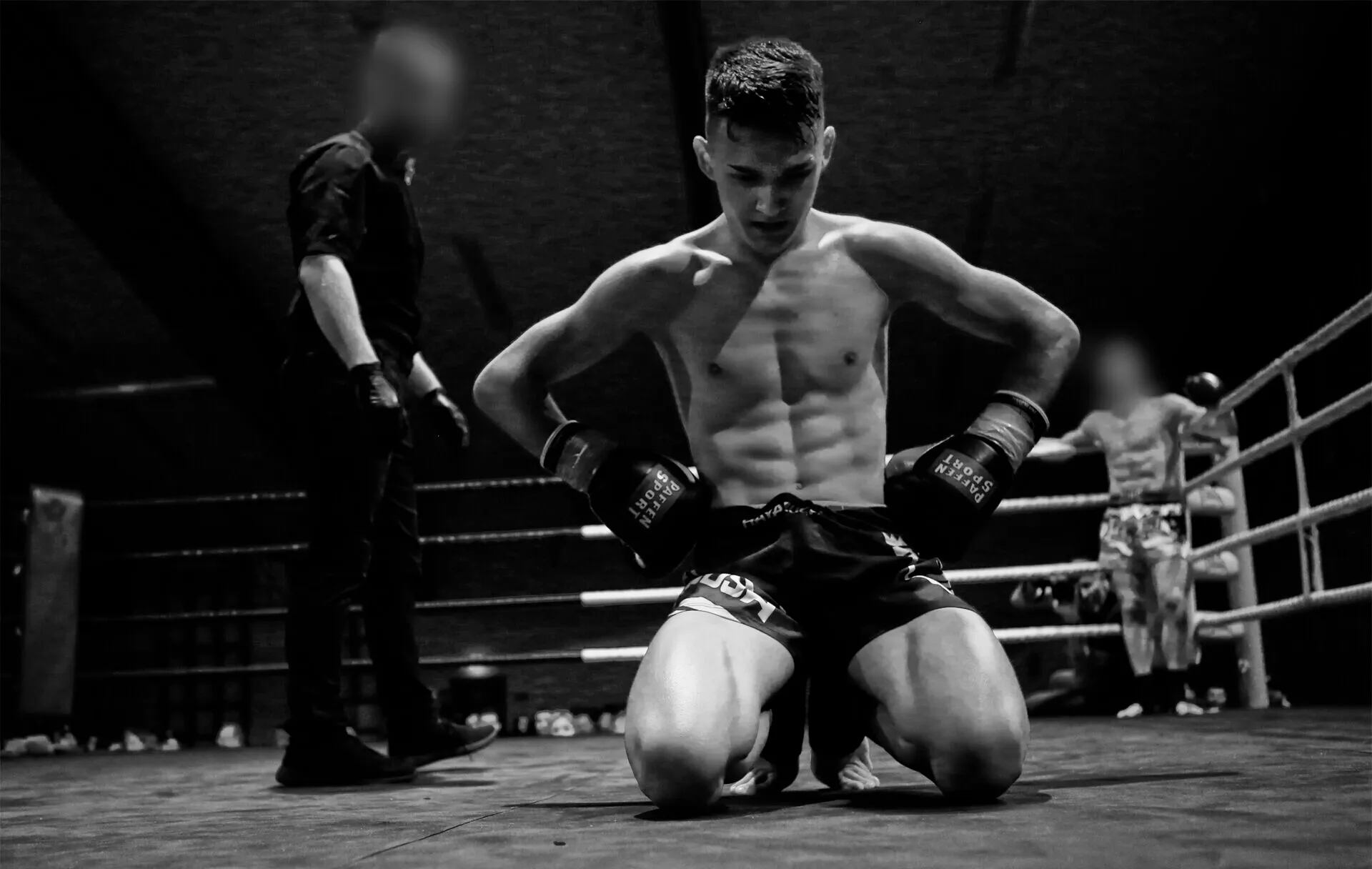 Anto kneeling alone in the ring after a fight